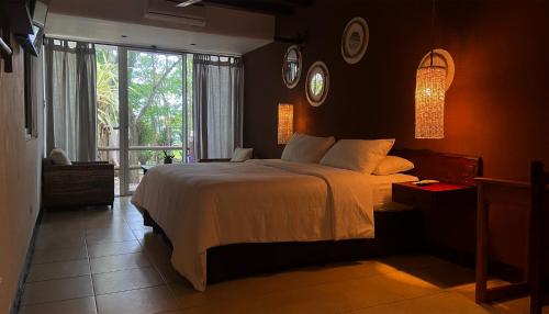 a bedroom with a large bed and a window at Hotel Maya Internacional in Flores