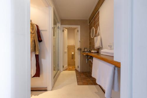 a bathroom with a sink and a counter with towels at The Lofts Boutique Hotel in Knysna