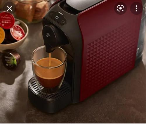 a coffee maker is making a cup of coffee at Casa Abiiani in Oradea