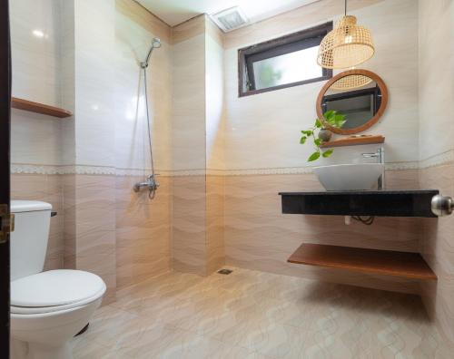 a bathroom with a toilet and a sink and a mirror at Hoianese Center Hotel - Truly Hoi An in Hoi An