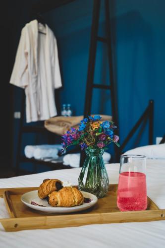 a table with a plate of food and a vase of flowers at Hotel Darchi Kazbegi in Stepantsminda