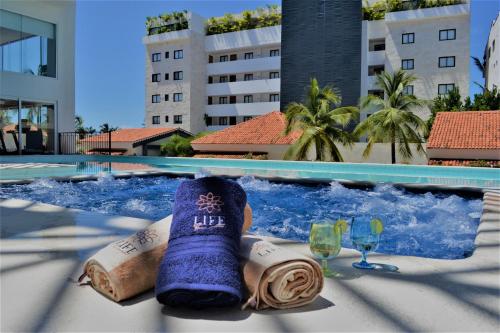 a pair of socks and wine glasses in a swimming pool at Steps from the Beach Condo Life Bucerias Golden Zone in Bucerías