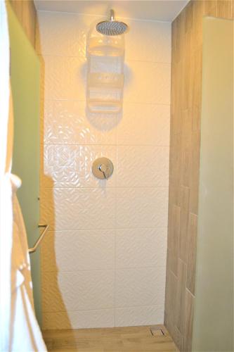 a bathroom with a shower with a glass wall at Steps from the Beach Condo Life Bucerias Golden Zone in Bucerías
