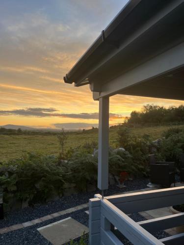 a view of a sunset from the porch of a house at Rockschapel Cabin 30B in Annacloy