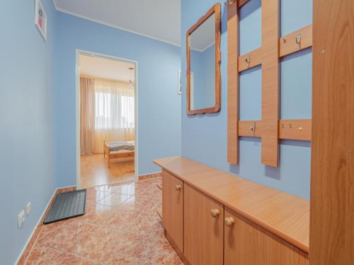 a room with blue walls and a desk with mirrors at Mieszkanie Centrum in Iława