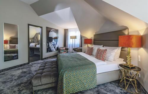 a bedroom with a large bed and a living room at Hotel du Nord, Hamburg-Volksdorf in Hamburg