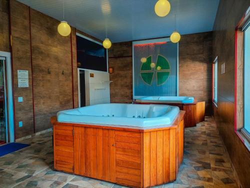 a large wooden bathroom with a large wooden tub at Hotel Fazenda Golden Park Campos do Jordão in Campos do Jordão