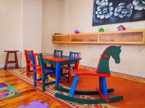a childrens play room with a table and chairs at Hotel Fazenda Golden Park Campos do Jordão in Campos do Jordão