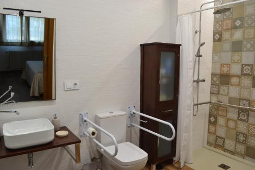 a bathroom with a toilet and a sink and a shower at Casa Rural La Madroña in Fuentelabrada de los Montes