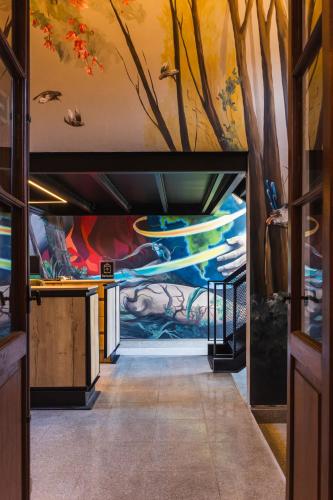 a hallway with a mural on the wall at Faz Hostel Boutique in Córdoba
