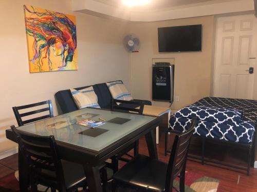a living room with a dining room table and a bed at 67-26 Austin Cove near subway, all shops, restaurants! Separate Entrance in New York