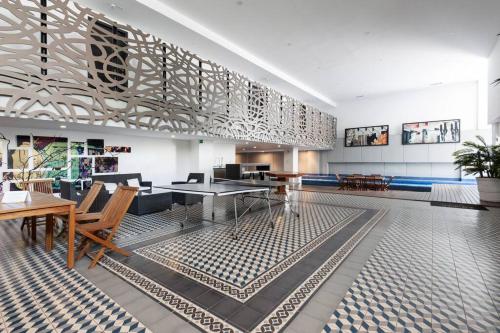 a dining room with tables and chairs in a building at Beautiful loft. King size bed. 150 Mbps internet. in Mexico City