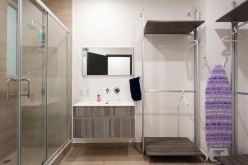 a bathroom with a sink and a shower at Beautiful loft. King size bed. 150 Mbps internet. in Mexico City