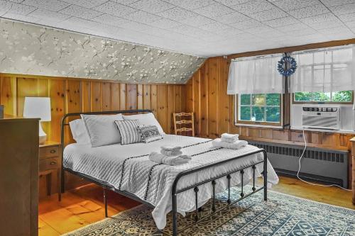 馬培黑德的住宿－Hollyhock House，卧室配有一张床铺,位于带木墙的房间内