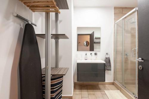 a bathroom with a sink and a shower at Chic loft! 150 BPS fiber optic internet in Mexico City