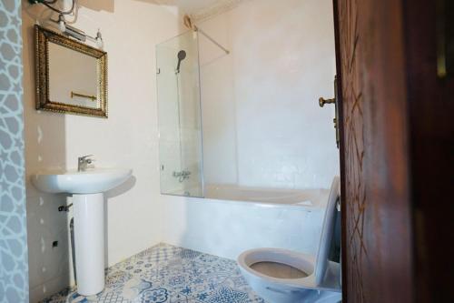 a bathroom with a sink and a toilet and a shower at Riad Amelia : Lalla Fatima Zohra Room in Tétouan