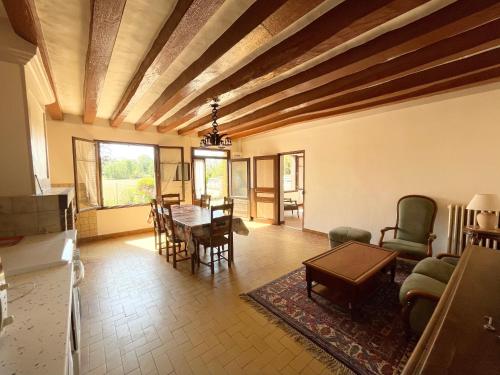 un salon avec une table et des chaises dans l'établissement Longère Tourangelle, à Bréhémont