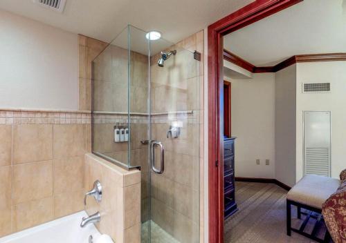 a bathroom with a shower with a glass door at Everline Resort & Spa Rentals by TO in Olympic Valley