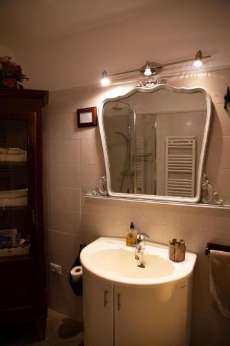 a bathroom with a sink and a mirror at BnB Trento in Trento
