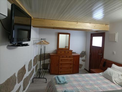 a bedroom with a bed and a flat screen tv at CIH - Constituição Invicta Home in Porto