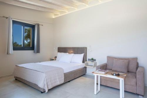 a bedroom with a bed and a couch at Lefkolia Retreat in Sivota