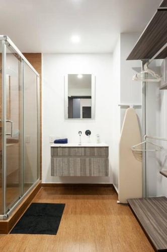 a bathroom with a sink and a mirror at 600 sq ft in trendy area, 150 BPS fiber optic in Mexico City