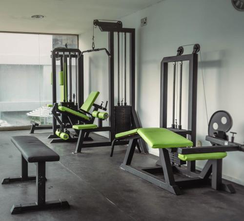 a gym with several exercise equipment in a room at Hotel Faranda Express Puerta Del Sol Barranquilla, A Member of Radisson Individuals in Barranquilla