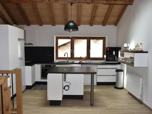 a kitchen with a sink and a table in it at Chalet Pralognan-la-Vanoise, 5 pièces, 10 personnes - FR-1-464-203 in Pralognan-la-Vanoise