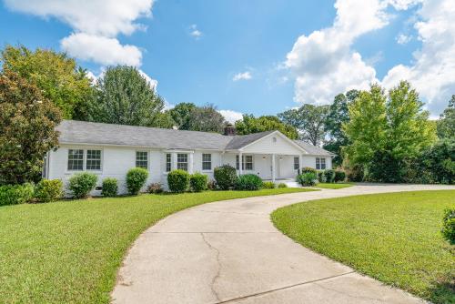 a white house with a driveway at Charming, Cozy Home close to Uptown, Airport & Whitewater Center in Charlotte
