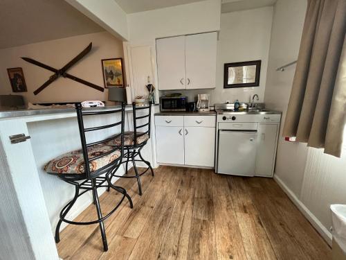 a kitchen with two chairs and a counter with a stove at June Lake Villager in June Lake
