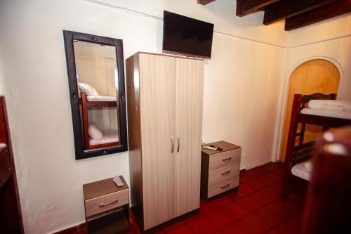 a bathroom with a mirror and a dresser and a cabinet at Casa Hotel Marbella Beach in Cartagena de Indias