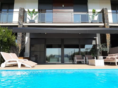 a house with a swimming pool next to a house at Ikasmendi in Rentería