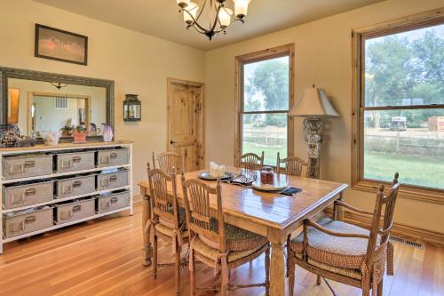 a dining room with a wooden table and chairs at Fruita Victorian Home with Hot Tub and Mountains! in Fruita