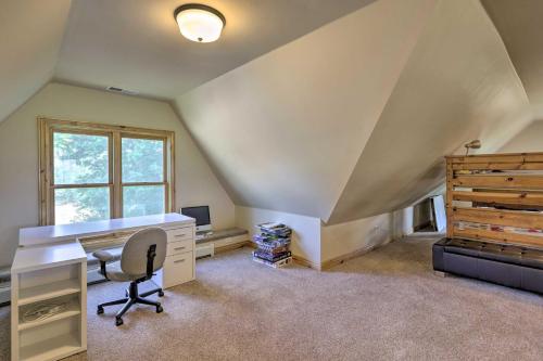 an attic office with a desk and a bed at Fruita Victorian Home with Hot Tub and Mountains! in Fruita