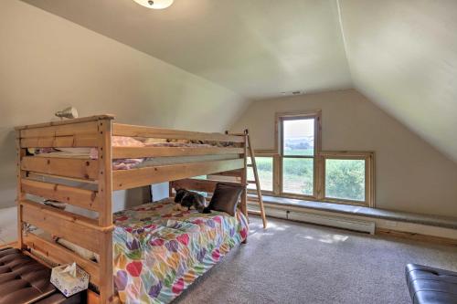 a bedroom with a bunk bed with a cat laying on it at Fruita Victorian Home with Hot Tub and Mountains! in Fruita