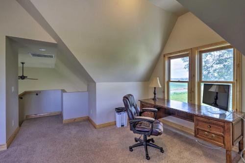 an office with a desk and a chair and a window at Fruita Victorian Home with Hot Tub and Mountains! in Fruita