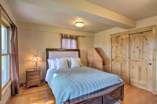a bedroom with a bed and a dresser and a window at Fruita Victorian Home with Hot Tub and Mountains! in Fruita