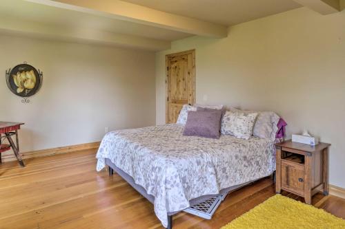 a bedroom with a bed and a wooden floor at Fruita Victorian Home with Hot Tub and Mountains! in Fruita