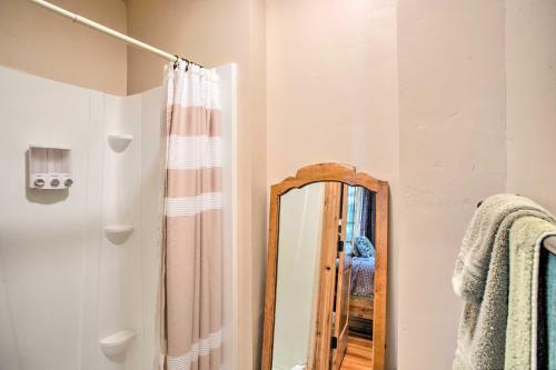 a bathroom with a mirror and a shower curtain at Fruita Victorian Home with Hot Tub and Mountains! in Fruita