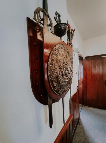 a artifact hanging on a wall in a hallway at Hotel Castelo Nacional Inn Campos do Jordão in Campos do Jordão
