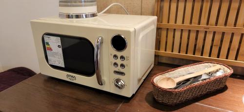 a toaster oven sitting on a table next to a basket at ETERNO SOL Loft Andino in Humahuaca