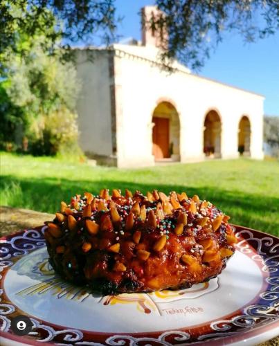 a cake sitting on a plate on a table at Casa Susanna Rural Sardinia in Sini