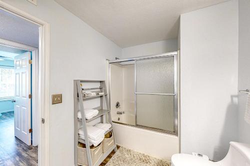 a white bathroom with a shower and a sink at Indian Lake 317 in Destin