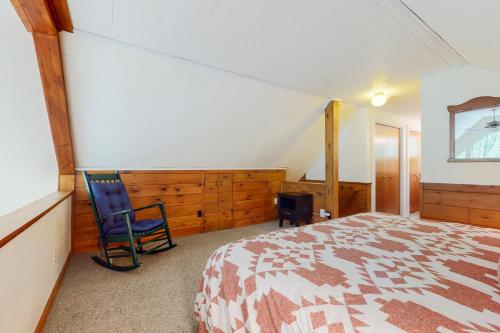 a bedroom with a bed and a chair in it at Riverbend in Bartlett