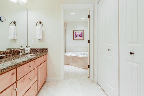 a white bathroom with a tub and a sink at Cobble Creek Pearl in Driggs