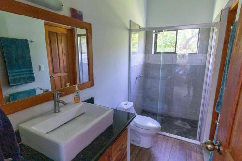 a bathroom with a sink and a shower and a toilet at Casa Paraíso - 3rd Floor in San Juan del Sur