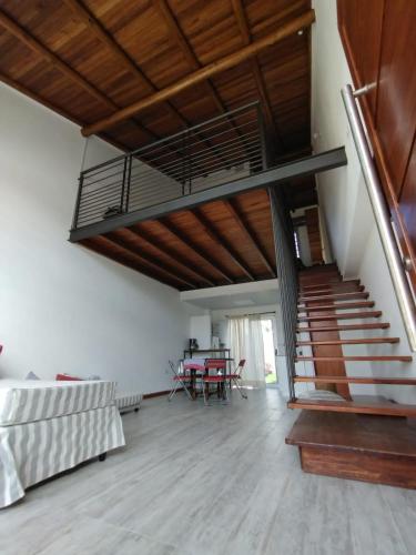 a living room with a staircase and a table at Loft Salto Chico in Concordia