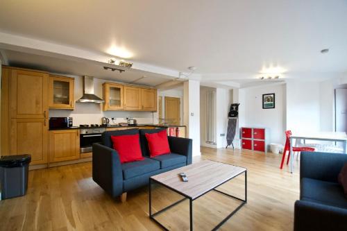 a living room with two couches and a table at 62-66 Farringdon Apartments by condokeeper in London