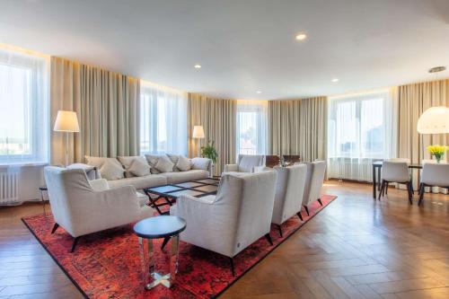 a living room with a couch and chairs and a table at Palace Hotel Tallinn, a member of Radisson Individuals in Tallinn