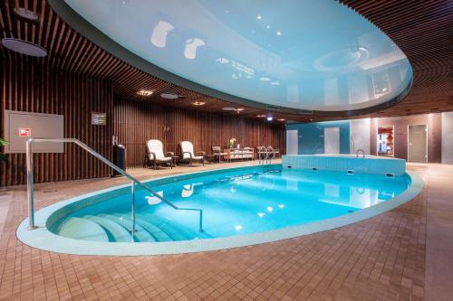 a large swimming pool in a hotel room at Palace Hotel Tallinn, a member of Radisson Individuals in Tallinn